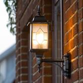 Photograph: Konstsmide Milano Black Upward Facing Exterior Wall Light Complete With Leaded Effect Acrylic Glass