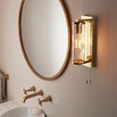 Photograph: Thorlight Kairo Single Bathroom Wall Light In Satin Brass With A Clear Ribbed Glass Shade - IP44