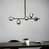 Photograph: Thorlight Nollan 5 Light Linear Bar Pendant Antique Silver With Smoked Glass Globes