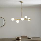 Photograph: Thorlight Nollan 5 Light Linear Bar Pendant Satin Brushed Gold With Frosted Glass Globes