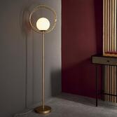 Photograph: Thorlight Ravi Brushed Gold Finish Floor Lamp Complete With Glossy Opal Glass Globe