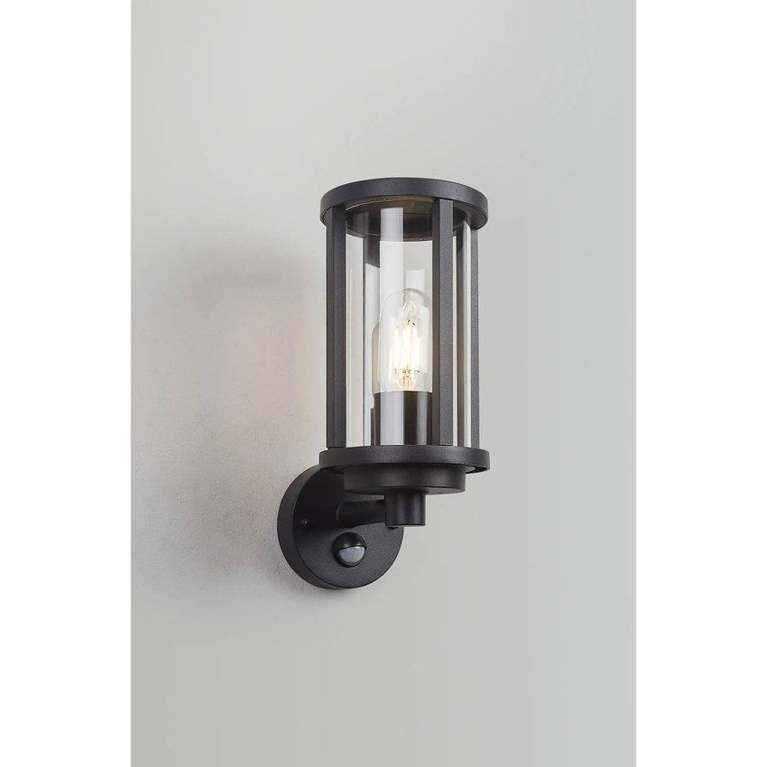 Photograph: Idolite Sannee Cylinder PIR Wall Lamp 1 Light IP44 Matt Black/Clear