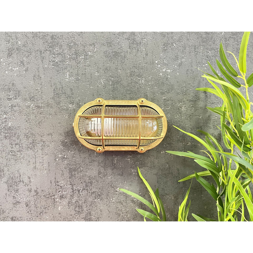 Photograph: Navigator Merchant Raw Brass Oval Bulkhead - IP64, Solid Brass, Coastal