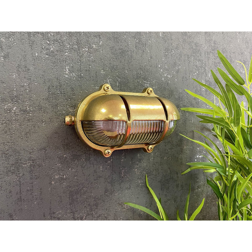 Photograph: Navigator Palaemon North Raw Brass Eyelid Oval Bulkhead - IP64, Solid Brass, Coastal